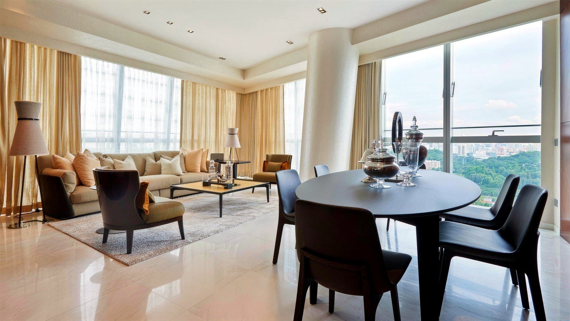 Open living and dining area on large-format marble tiles